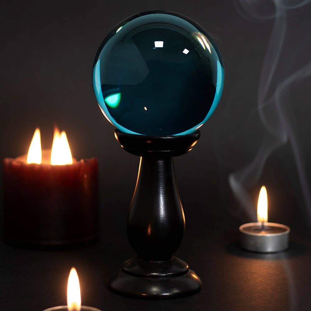 Petite boule de cristal bleu sarcelle sur support